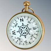 A round brass cased compass clock with large lenses either side