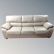 A Scandinavian cream leather three seater settee,