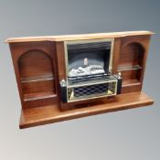 A log effect electric fire in mahogany surround