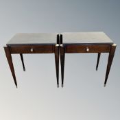 A pair of contemporary black vinyl topped lamp tables