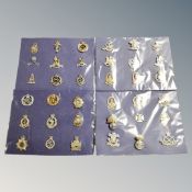 Thirty-six British Army cap badges mounted on card