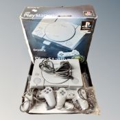 A Sony Playstation 1 with leads and controllers in original box