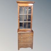 A mahogany four drawer chest with glazed cabinet above