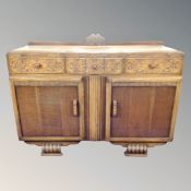 A 1930's carved oak sideboard,