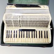 A Scandalli Symphony Four piano accordion in case