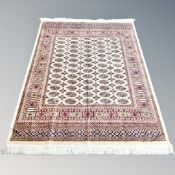A machine made Tekke design rug on cream ground,