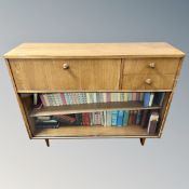 A teak sliding glass door bookcase containing various volumes,