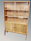 A teak sliding glass door bookcase,