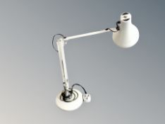 A metal angle poise lamp.