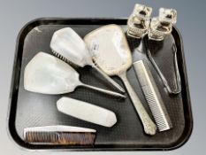 A silver four-piece dressing table set, further silver plates mirror and comb,