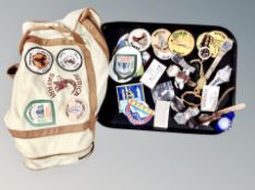 A tray of watches, sew on badges,