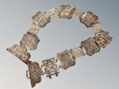 A Chinese silver belt, composed of sixteen panels decorated with flora and fauna,