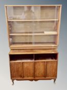 A sliding teak glass door bookcase width 100 cm together with a further audio cabinet