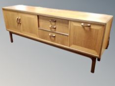 A mid century teak long low sideboard,