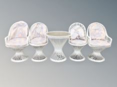 A suite of white wicker furniture comprising of four chairs and occasional table
