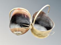 Two copper/brass coal helmets with tongs.