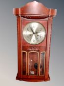 A stained beech 31 day wall clock