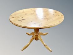 A contemporary pine dining table and four chairs