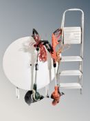 A set of aluminium steps together with a plastic topped folding table and two garden strimmers