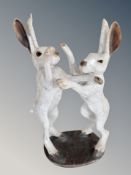 Brian Andrew : A raku fired figure group of two fighting hares, signature under base,