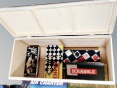 A painted mid century blanket box containing a quantity of board games, Generation Game, Cluedo,