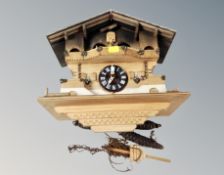 A Swiss cuckoo clock with pendulum and weights