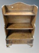 A set of mahogany waterfall bookshelves fitted a drawer