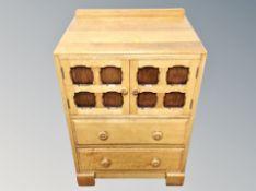 A 20th century oak linen cabinet and similar corner cabinet