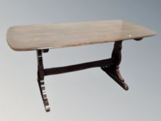 An Ercol elm and beech refectory dining table together with six Fleur de Lys chairs