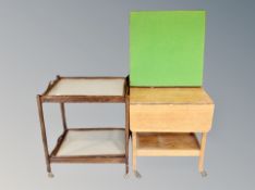 An oak two tier flap sided serving trolley fitted a drawer together with an oak two tier trolley