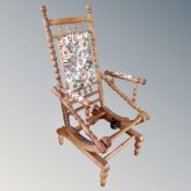 A 20th century continental oak glider rocking chair (lacking seat pad)