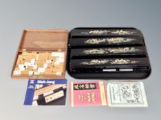 A cased Mah Jong set with instructions, further Mah Jong set,
