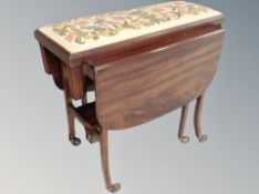 A 20th century mahogany flap sided serving trolley together with a tapestry duet footstool
