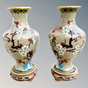 A pair of Japanese cloisonné vases on wooden stands,