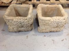 A pair of concrete garden brick planters