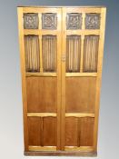 A 1920's oak linen fold wardrobe