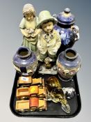 A pair of 1930's chalk figures, boy and girl, glass elephant, paperweight,