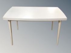 A mid 20th century melamine topped kitchen table and a set of four chrome tubular metal and white