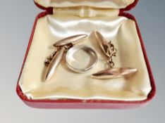 A 9ct white gold wedding band and a pair of 9ct yellow gold torpedo shaped cufflinks