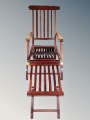 A teak steamer garden armchair with footrest