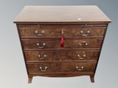 A George III style mahogany four drawer chest with slide