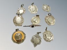 A 9ct gold garnet bar brooch and a group of nine watch fobs