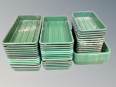 A quantity of plastic seeding trays