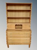 A blonde oak bookcase, fitted drawer beneath,