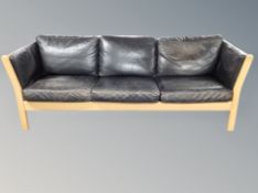 A Danish black leather three seater settee