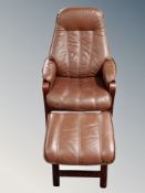 A brown leather beech framed armchair with stool