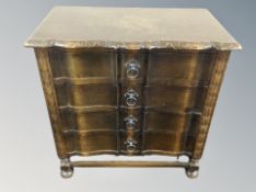 A carved oak four drawer low chest,