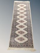 An Afghan Bokkara runner on beige ground 195 cm x 65 cm