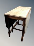 An oak drop leaf dining table