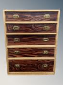A teak effect five drawer low chest,